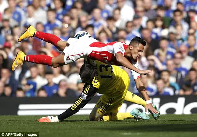 Thibaut Courtois suffered a blow when he came out to challenge Alexis Sanchez but he played on after