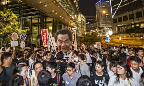 Public enemy No 1 … protesters in Hong Kong hold up a banner of CY Leung.  Photo: Xaume Olleros/AFP/